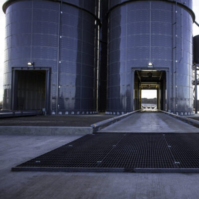 two shiny black silos with drive through passageways. 