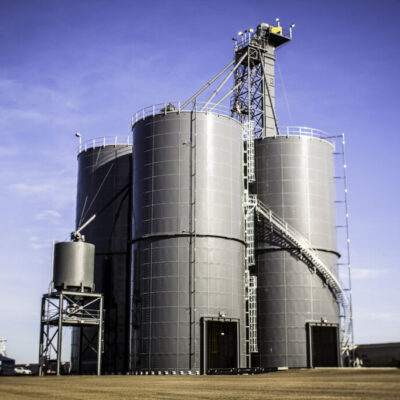 3 grey silos with drive through passageways 